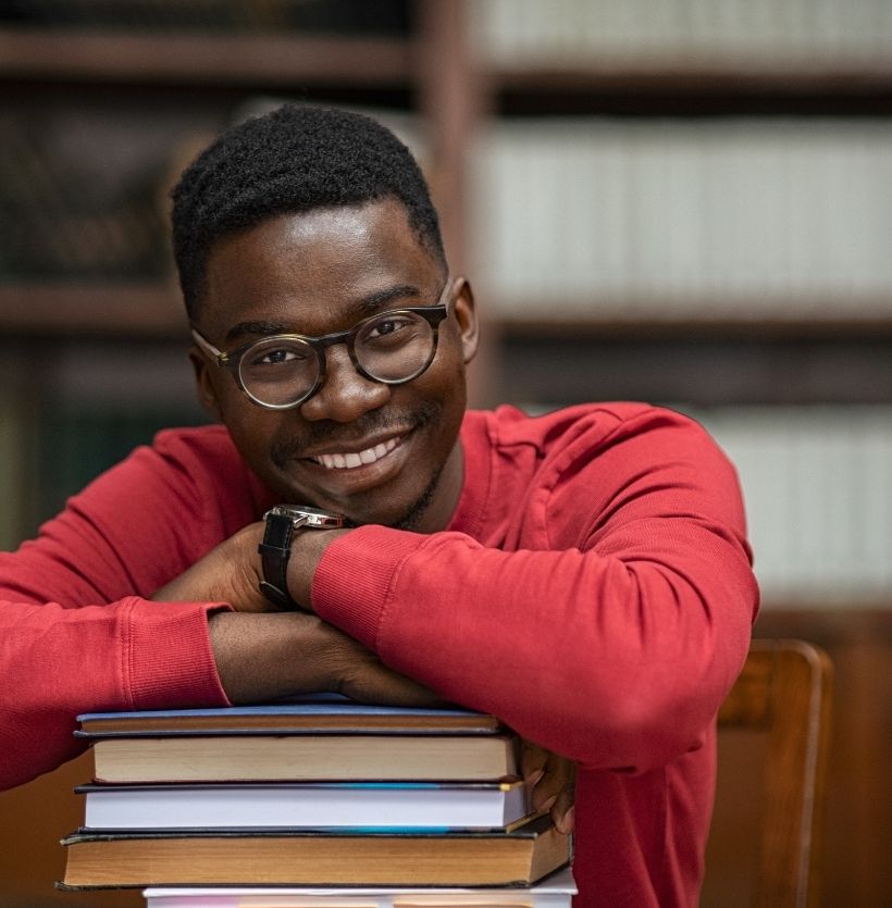 Image of a satisfied student in a library.